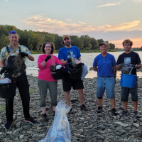 Get the Lead Out volunteers post on Blue Grass Island during a clean-up in August 2022.