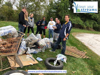 Volunteers posing with trash collected at CYS 22