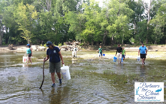 Volunteers collecting fishing line and tackled along a stream