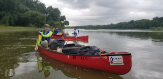 Volunteers paddling during the Otsego Island Cleanup in 2018