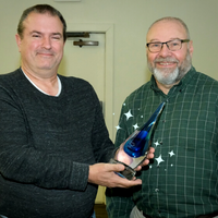 A photo of PCS Board President Bob Neubert presenting Jeff MacKenzie with the PCS 2022 Annual Stewardship and Involvement Award.