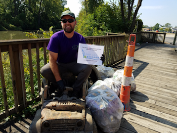 Clean Your Streams volunteer with trash found