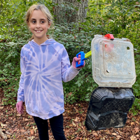 A volunteer removing marine debris with a grabber.